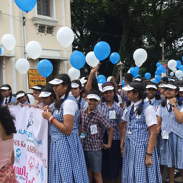 Schoolgirls holding balloons during the march