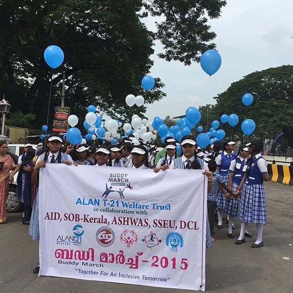 The Buddy March 2015 banner leads the procession