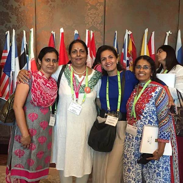 Delegates in front of the flags of participating countries